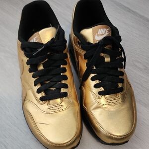 Nike Metallic Gold Sneakers with Black Accents